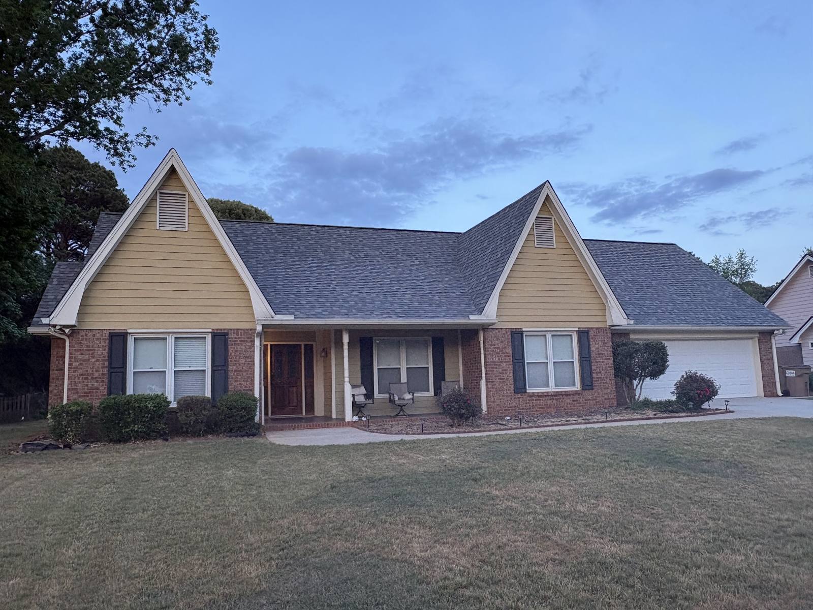 Brick ranch house with a new dark shingle roof