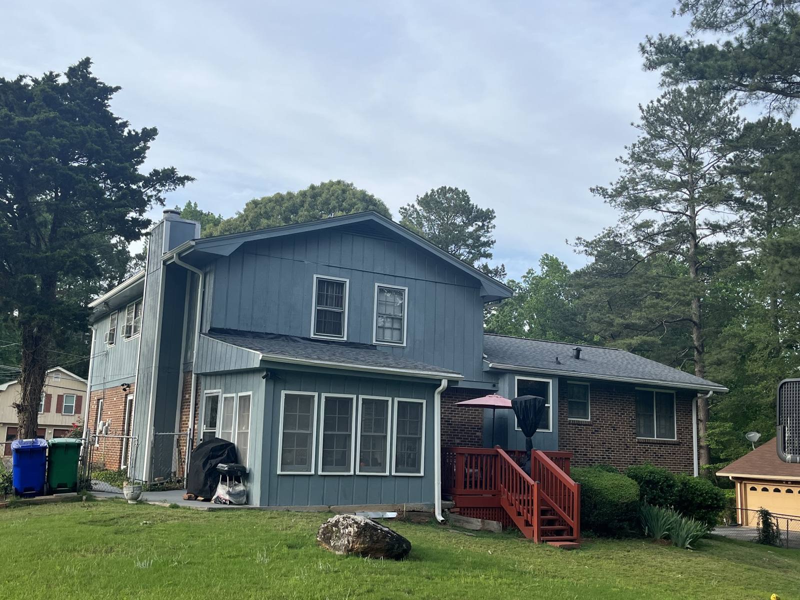 Blue-sided two-story house with a new roof