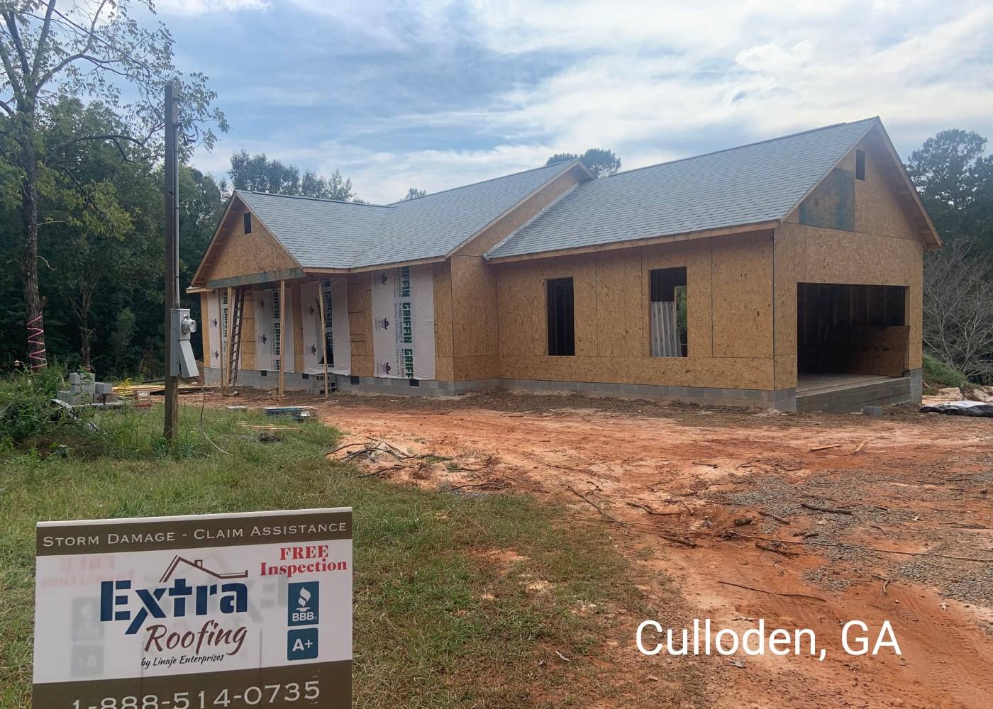 New-build home in Culloden, GA with a new roof and an Extra Roofing sign