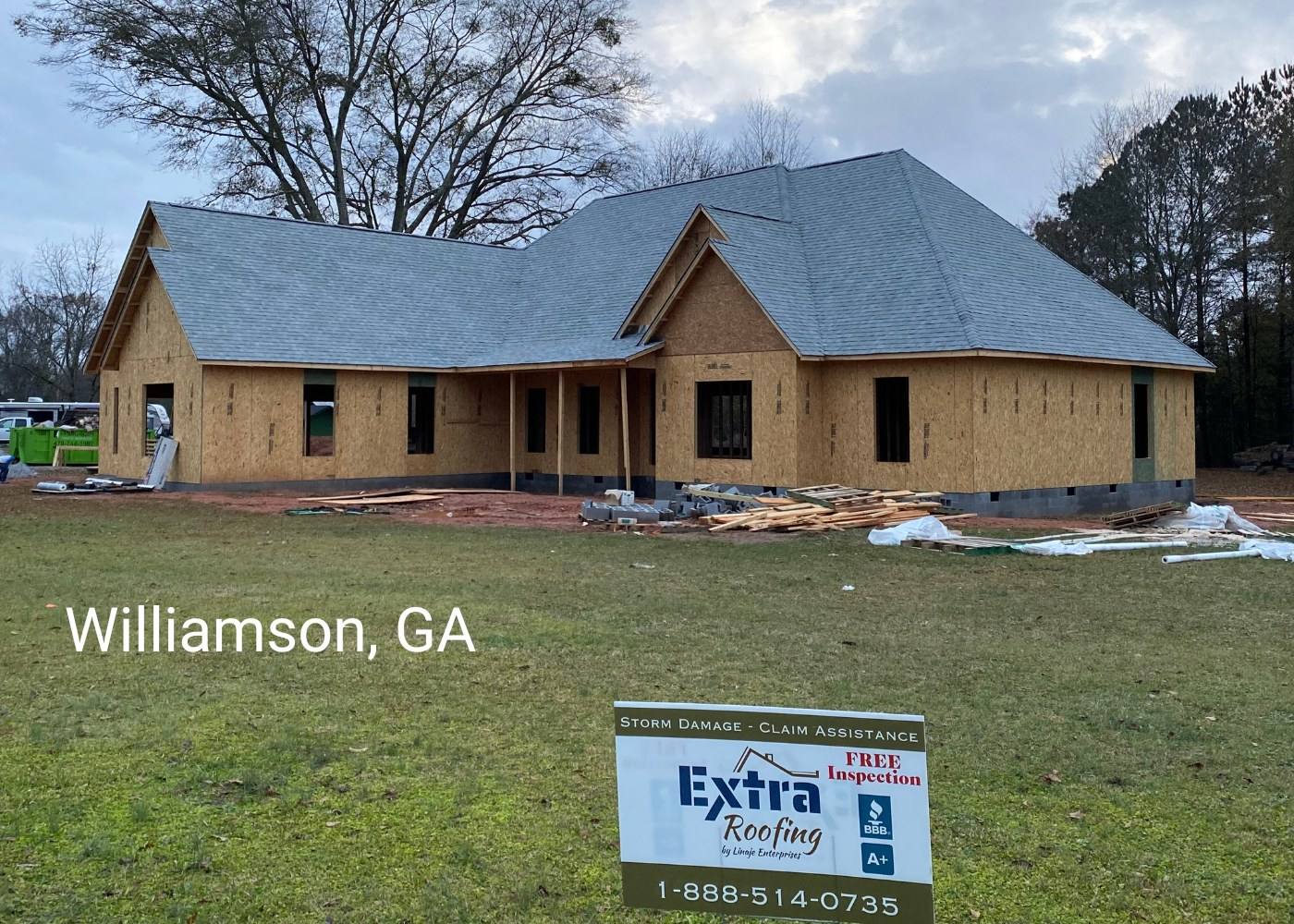 New-build home in Williamson, GA with a new roof and an Extra Roofing sign