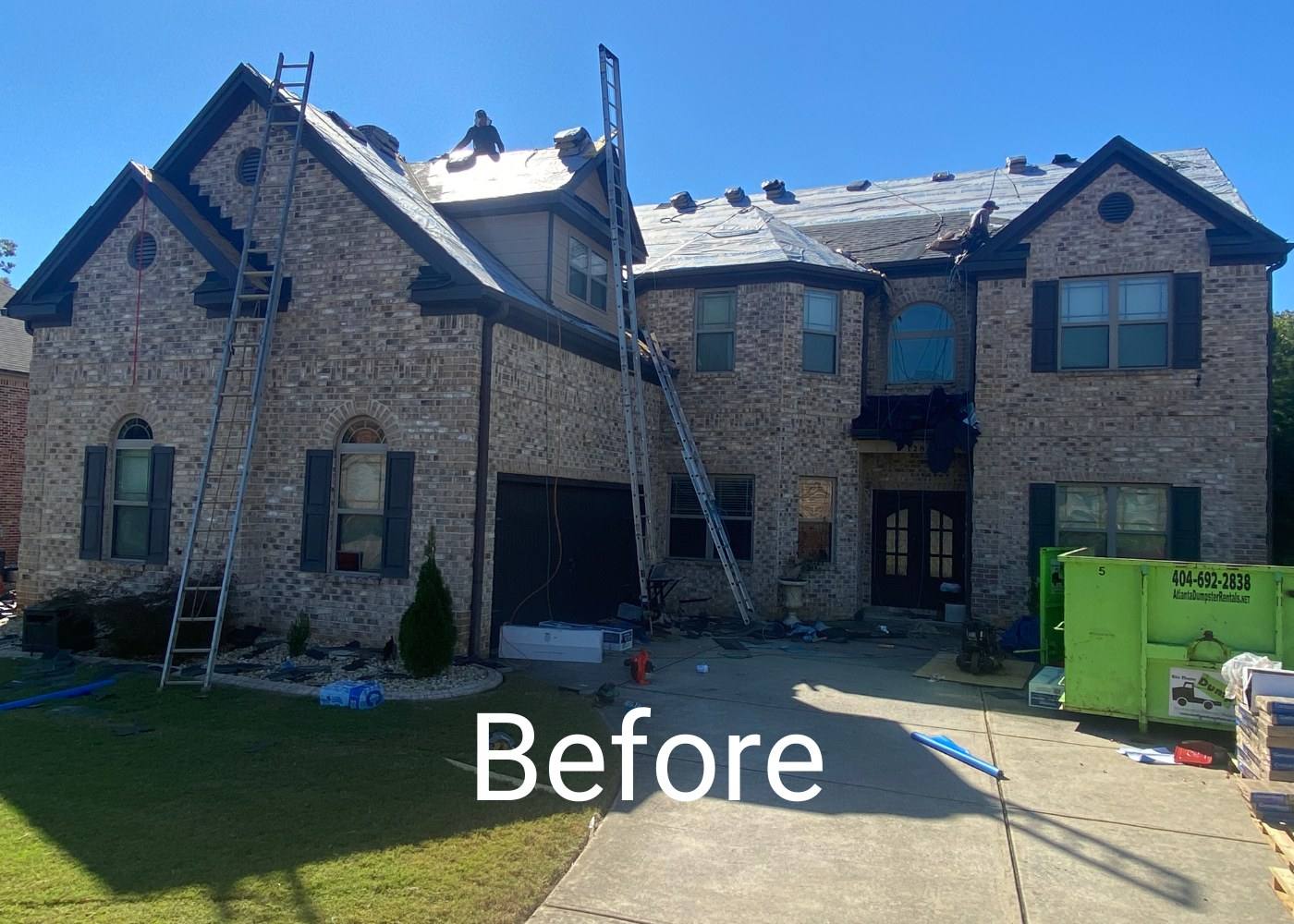 Before: ladders up and a dumpster on the drive of a two-story brick home in Stockbridge